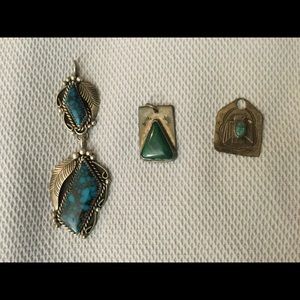 Three silver and turquoise charms.